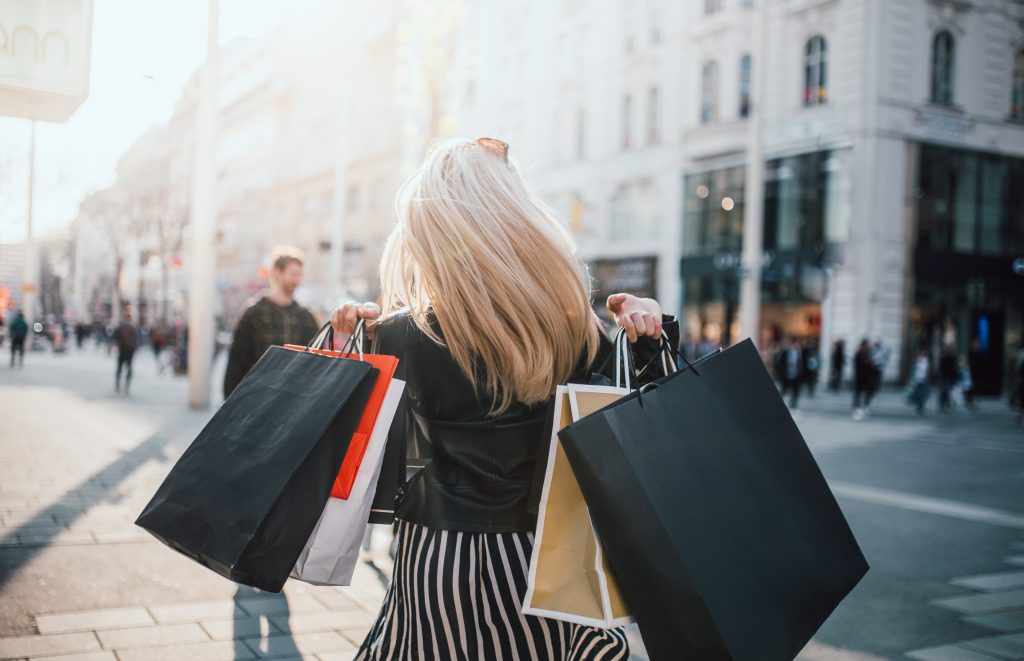 A girl carrying multiple shopping bags. 